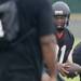 Ypsilanti Community High School quarterback Amari Jenson looks to hand the ball off during practice in the rain at the school on Monday, August 12, 2013. Melanie Maxwell | AnnArbor.com